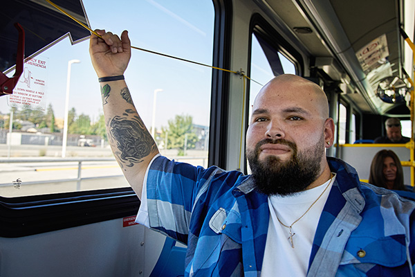 A man on the bus uses the cord to request a stop