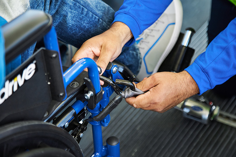 Close up of hands buckling in a wheelchair