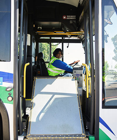 A bus operator lowers the lift