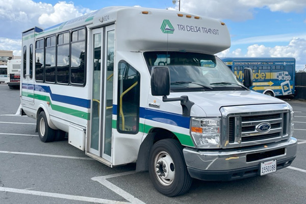 A paratransit van in a parking lot