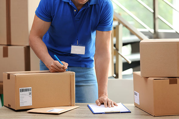 person writing on top of a parcel