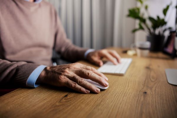 Man clicking his mouse for his computer