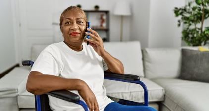 women in wheelchair talking on her mobile phone