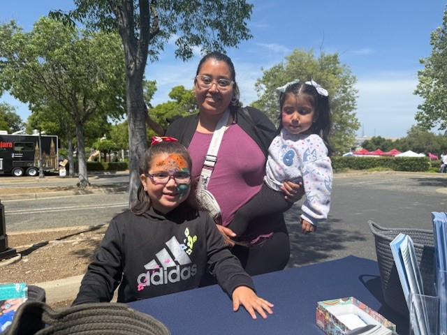 Little girls with face painted at STEM 2025